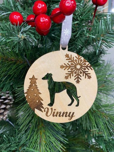  wooden ornament featuring a greyhound silhouette, a tree, and snowflakes, labelled "Vinny".